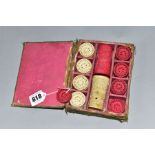 A LATE 19TH CENTURY BOXED SET OF CARVED IVORY DRAUGHTS/CHEQUERS PIECES AND TWO DICE SHAKERS, the red