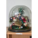 A VICTORIAN GLASS OVAL DOME ON EBONISED BASE, containing a wicker basket holding an arrangement of