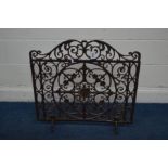 A CAST IRON FIRE GUARD with fleur-de-lis, floral and scroll decoration