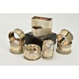 FOUR SETS OF TWO SILVER NAPKIN RINGS, to include a pair of plain polished foliate edge detailed