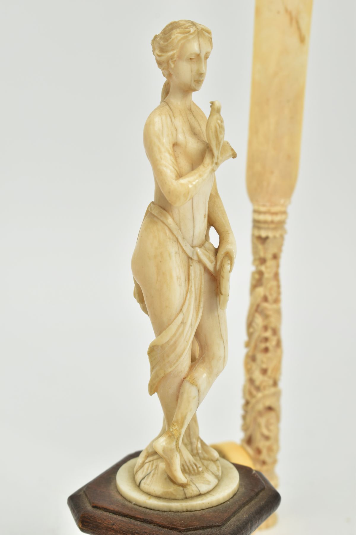 A 19TH CENTURY CARVED IVORY FIGURE OF A SCANTILY CLAD FEMALE WITH A BIRD AND PIPES, mounted on a - Image 8 of 9