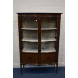 AN EDWARDIAN MAHOGANY, STRUNG AND INLAID BOWFRONT DISPLAY CABINET, with two glazed doors enclosing