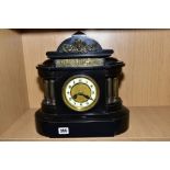 A LATE 19TH CENTURY BLACK SLATE MANTEL CLOCK OF ARCHITECTURAL FORM, fitted with brass columns, the
