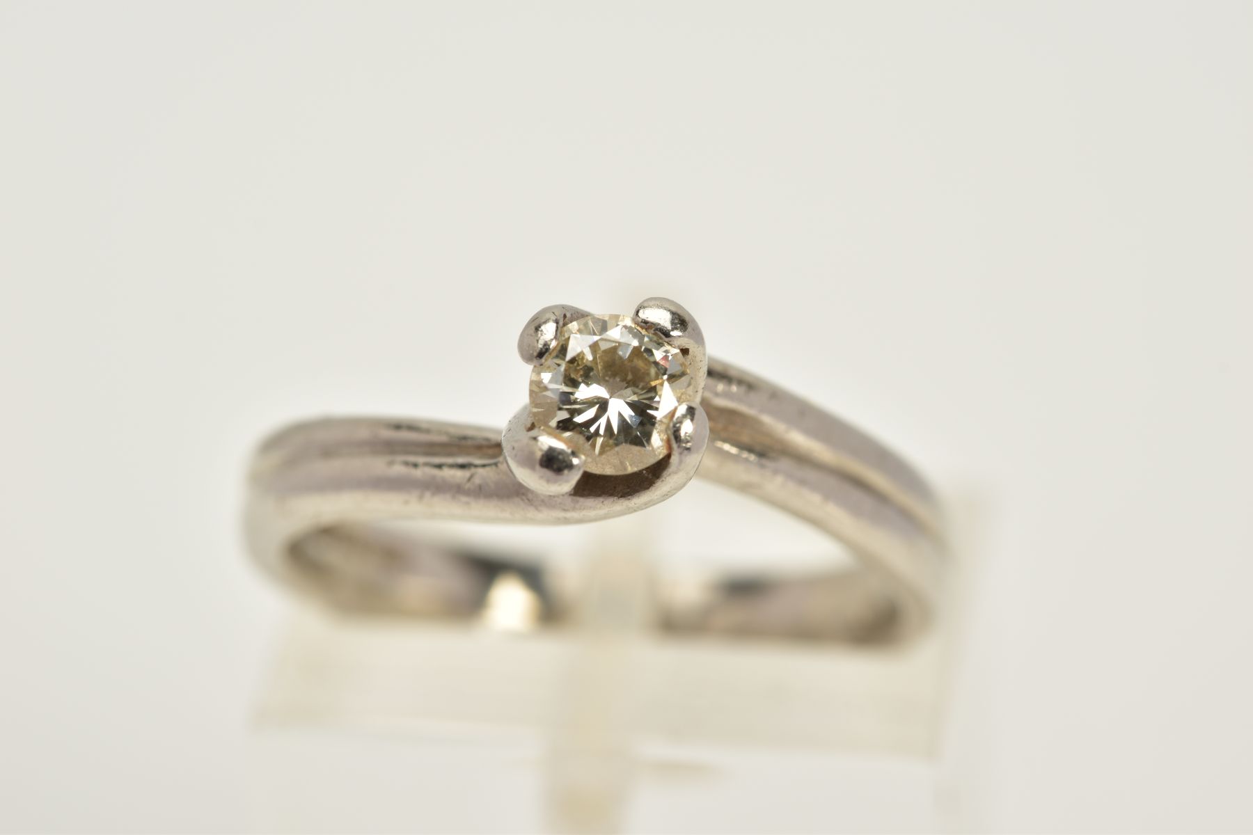 A PLATINUM SINGLE STONE DIAMOND RING, of crossover design, with a claw set round brilliant cut - Image 5 of 5