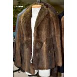 A LADIES RACOON FUR JACKET, having feature self fur pom-pom type fastening, stand up collar and side