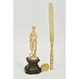 A 19TH CENTURY CARVED IVORY FIGURE OF A SCANTILY CLAD FEMALE WITH A BIRD AND PIPES, mounted on a