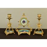 A LATE 19TH CENTURY GILT METAL AND PORCELAIN CLOCK GARNITURE, the drum shaped clock mounted in an