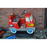 A COIN OPERATED CHILDS RIDE ON FIRE ENGINE fibre glass in construction with 20p coin mechanism,