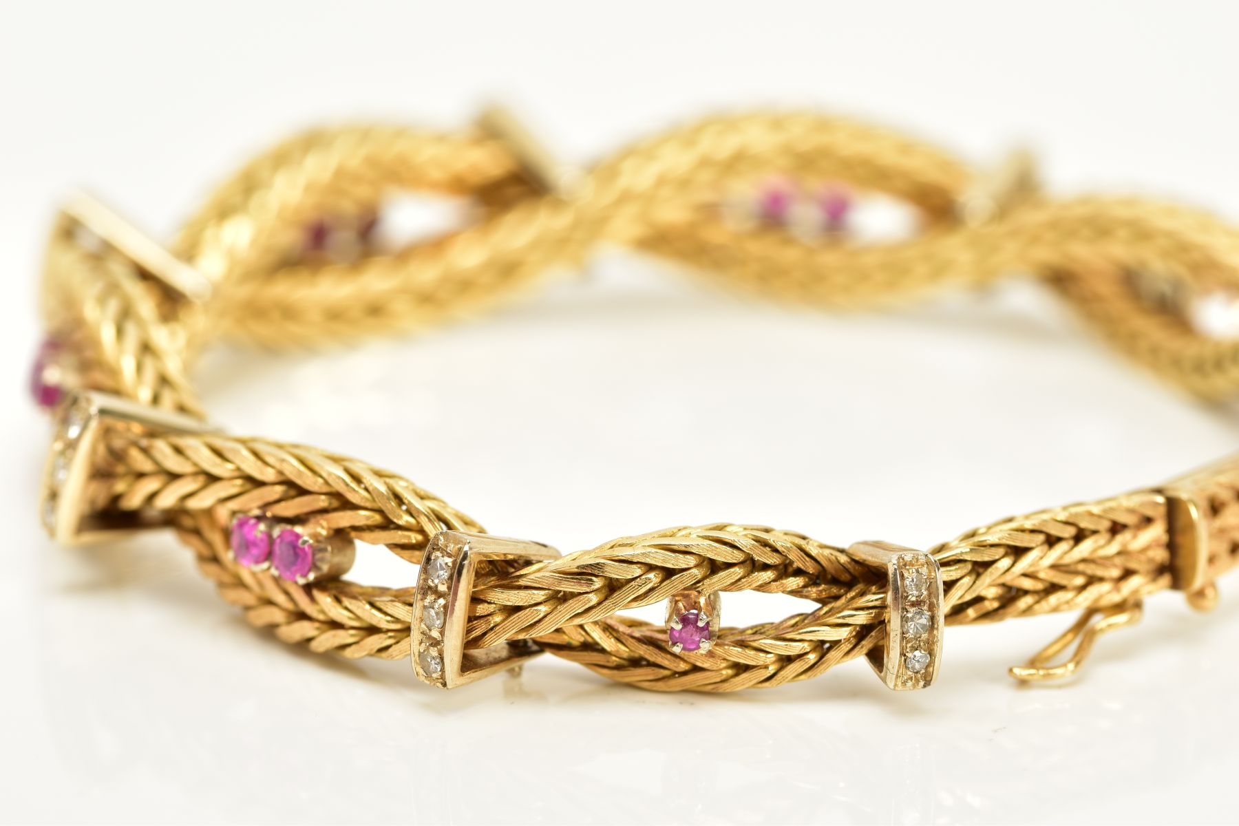 A MODERN YELLOW METAL DIAMOND AND RUBY BRACELET, designed as a twisted box chain bracelet, seven - Image 3 of 6