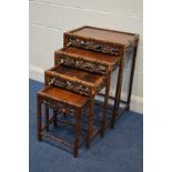 AN ORIENTAL ROSEWOOD QUARTETTO NEST OF FOUR TABLES, fruiting vine and foliate frieze, on carved legs