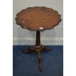 A VICTORIAN WALNUT GAMES TABLE, wavy top, on a fluted column and tripod legs, diameter 54cm x 72cm