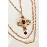 AN EARLY 20TH CENTURY GARNET PENDANT NECKLACE, the openwork pendant/brooch of scroll design, set