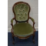 A VICTORIAN WALNUT SPOON BACK OPEN ARMCHAIR with green upholstery