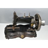 A SEIDEL & NAUMANN CAST IRON SEWING MACHINE, mounted on a decorated base, some paint loss and