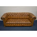 A TAN LEATHER BUTTONED CHESTERFIELD SOFA, along with later cushions, width 205cm