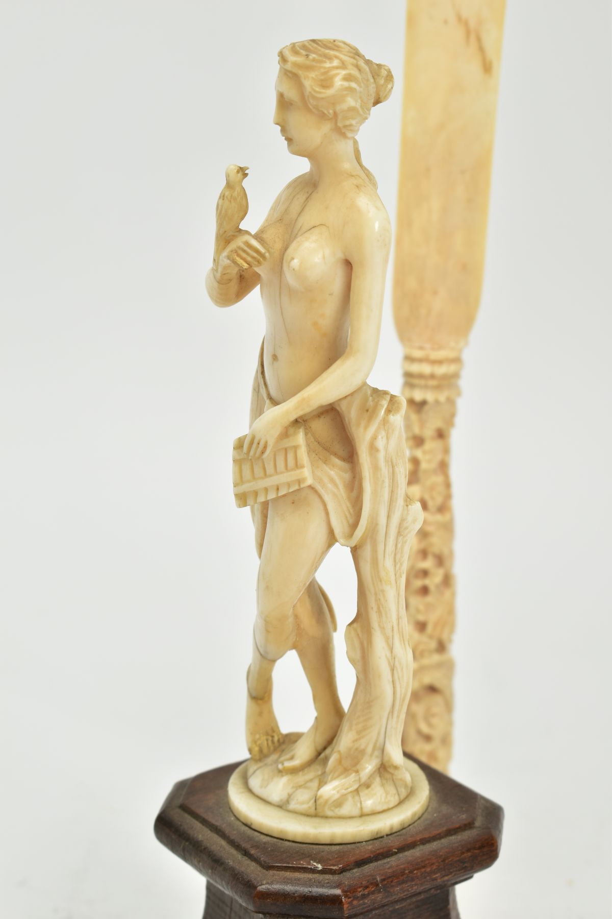 A 19TH CENTURY CARVED IVORY FIGURE OF A SCANTILY CLAD FEMALE WITH A BIRD AND PIPES, mounted on a - Image 7 of 9