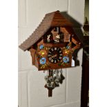 A MID 20TH CENTURY GERMAN WOODEN CHALET SHAPED CUCKOO CLOCK, with four spinning musicians below