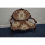 A VICTORIAN WALNUT TWO SEATER SOFA, with foliate decoration, oval back to swept open and scrolled