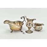 A SILVER SAUCE BOAT AND TWO CREAMERS, the sauce boat of plain design on cabriole legs and pad