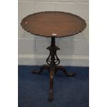 AN EARLY 20TH CENTURY MAHOGANY CIRCULAR DISH TOP TRIPOD TABLE, with a wavy edge, turned and tulip