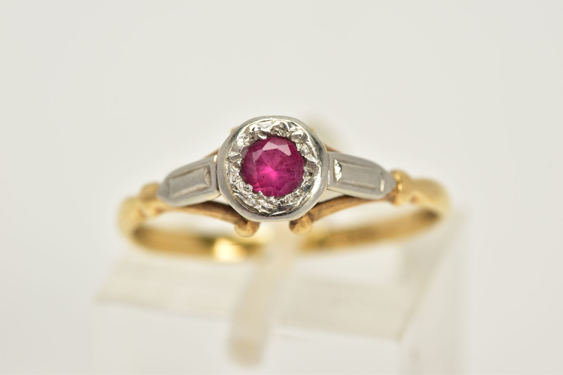 A YELLOW METAL RUBY RING, designed with a single circular cut ruby within a collet mount, textured - Image 4 of 4