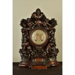 A LATE 19TH CENTURY CARVED OAK MANTEL CLOCK OF BAROQUE SCULPTURAL AND ARCHITECTURAL FORM, copper and