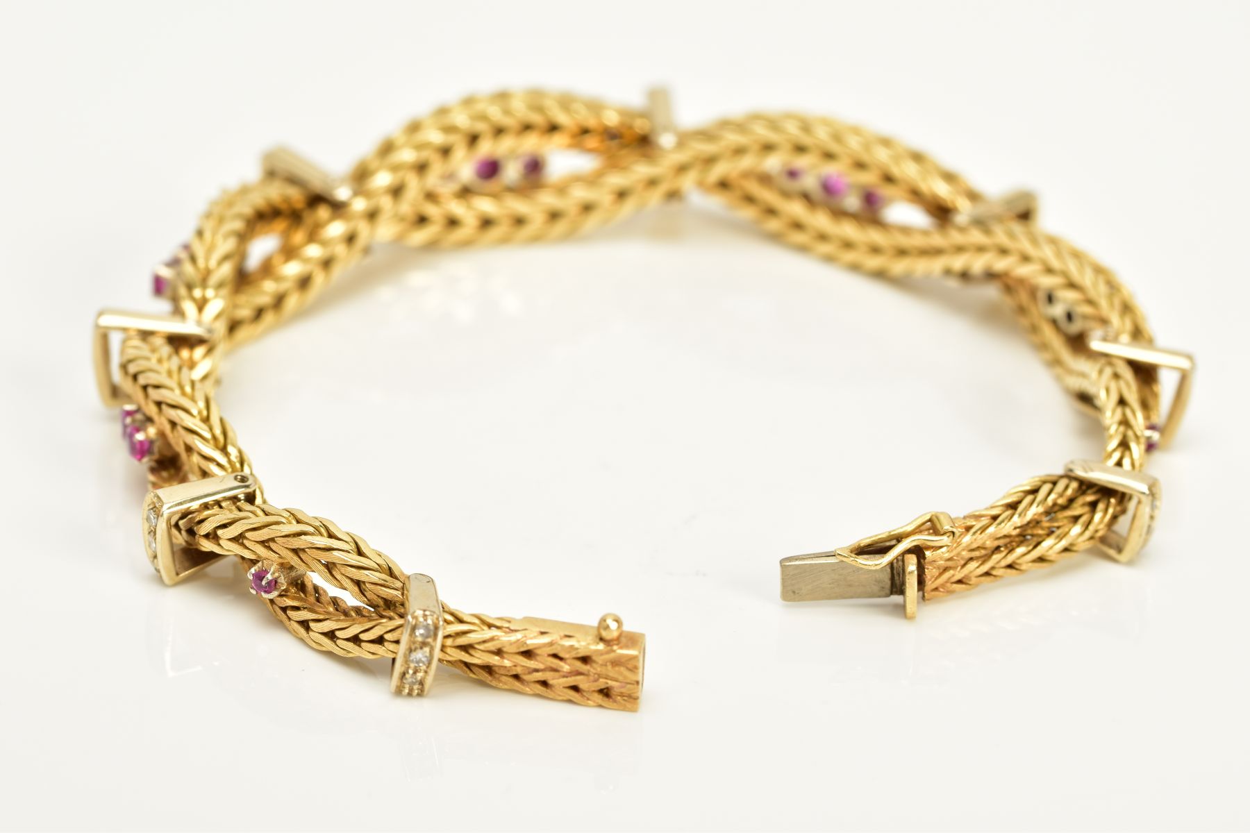 A MODERN YELLOW METAL DIAMOND AND RUBY BRACELET, designed as a twisted box chain bracelet, seven - Image 5 of 6