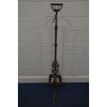 AN EARLY 20TH CENTURY ART NOUVEAU BRASS TELESCOPIC LAMP, with foliate decoration and triple legs,