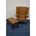 A TAN LEATHER BUTTONED PORTERS ARMCHAIR, on mahogany legs, along with a later cushion and a