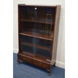 A MAHOGANY SLIDING GLAZED TWO TIER BOOKCASE, with two drawers, on ball and claw legs, width 92cm x