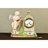 A LATE 19TH CENTURY CONTINENTAL PORCELAIN CASED MANTEL CLOCK, modelled as a cherub drawing beside