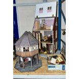 A WOODEN DOLLS HOUSE MODELLED AS A VICTORIAN CORNER SHOP, ground floor shop with a two storey flat