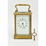 A BRASS GLASS SIDED STRIKING CARRIAGE CLOCK, with a white dial, Roman numerals, the movement