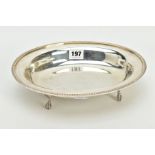 A CONTINENTAL SILVER ENTREE DISH, the plain polished dish with an embossed detailed rim, raised on