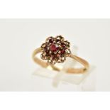 A 9CT GOLD GARNET CLUSTER RING, of an openwork floral design set with nine circular cut garnets,