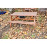 A MODERN SLATTED PINE PICNIC TABLE with two integrated bench seats, width 148cm