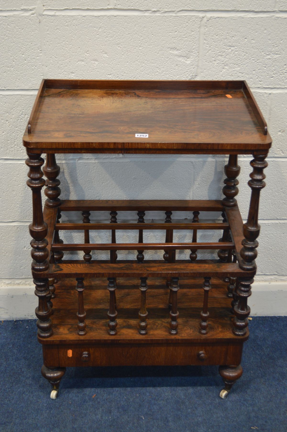 A VICTORIAN ROSEWOOD CANTERBURY, with a gallery top, turned and fluted supports, three divisions