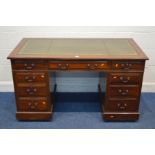 AN EARLY 20TH CENTURY MAHOGANY PEDESTAL DESK, with a green and gilt banded leather inlay top, long