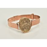 A 9CT ROSE GOLD LOCKET BANGLE, designed with a 9ct gold floral engraved oval locket, hallmarked