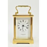 A MODERN QUARTZ BRASS CARRIAGE CLOCK, measuring approximately 110mm in height, excluding the handle