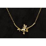 A MODERN DIAMOND NECKLACE, designed as a dragonfly textured finish in yellow and white metal,