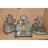 THREE LATE VICTORIAN SILVER PLATED CRUET STANDS, comprising two six bottle cruets and a five