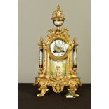 A LATE 19TH CENTURY GILT METAL AND PORCELAIN MANTEL CLOCK, hand painted urn finial front panel and