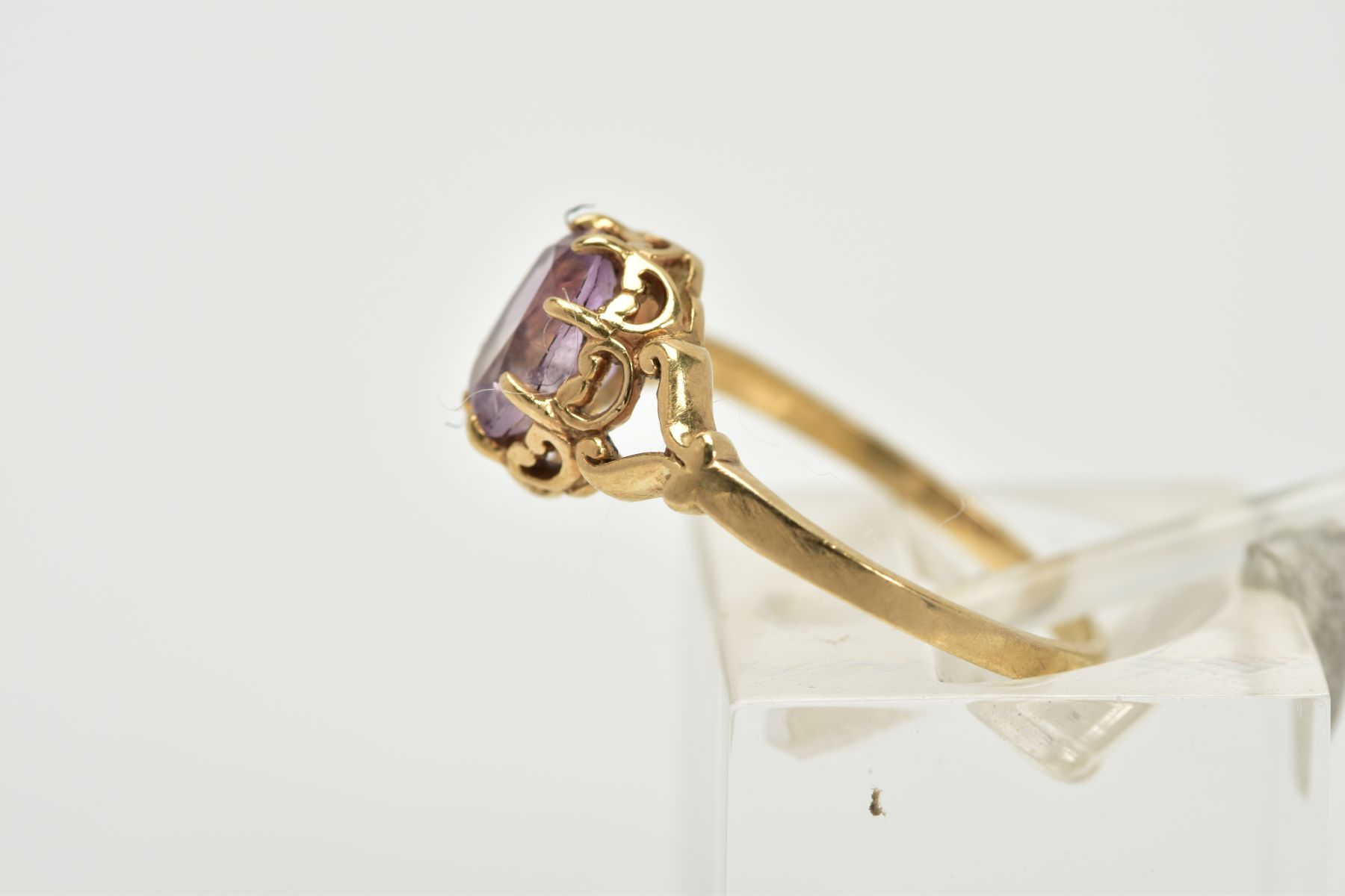 A 9CT GOLD AMETHYST RING, designed with a claw set, oval cut amethyst within an open work gallery, - Image 2 of 3