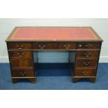 A MAHOGANY PEDESTAL DESK, with a red and gilt tooled leather inlay top, and nine various drawers,