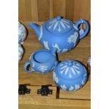 A WEDGWOOD BLUE JASPERWARE THREE PIECE TEA SERVICE, comprising teapot, covered sugar bowl and milk