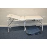 A FOLDING MASSAGE TABLE with adjustable back rest and aperture for face along with a carrying bag,