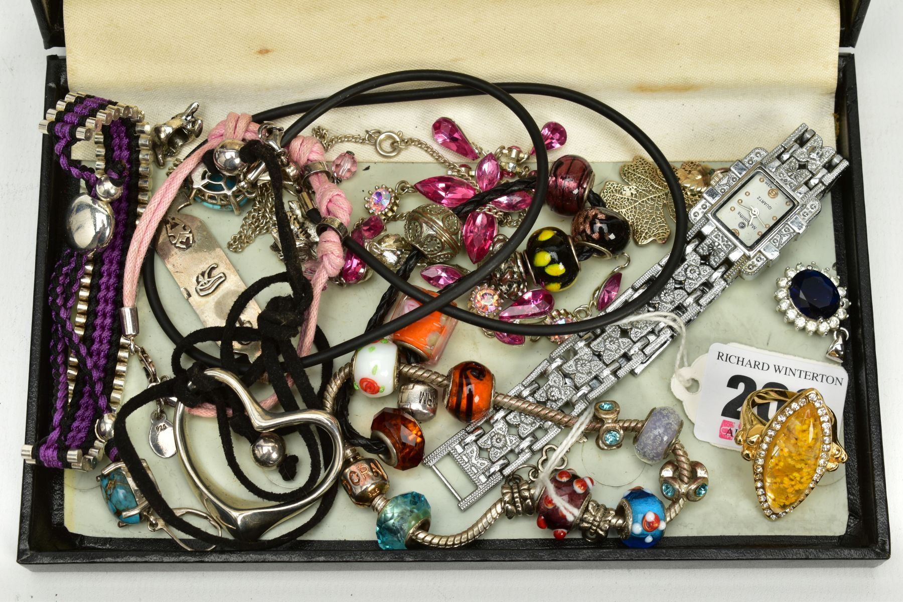 A SELECTION OF COSTUME JEWELLERY, to include two white metal charm bracelets with charms, a pink