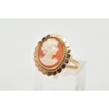 A YELLOW METAL CAMEO RING, the cameo of oval design depicting a lady in profile, within a collet