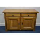 A SOLID GOLDEN OAK SIDEBOARD, with two drawers above double fielded panel cupboard doors, width